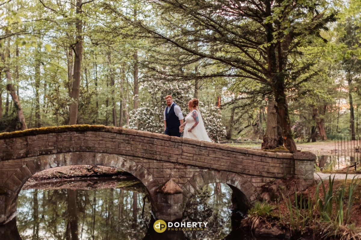 Bride and groom at kissing bridge at Hogarths in Solihull