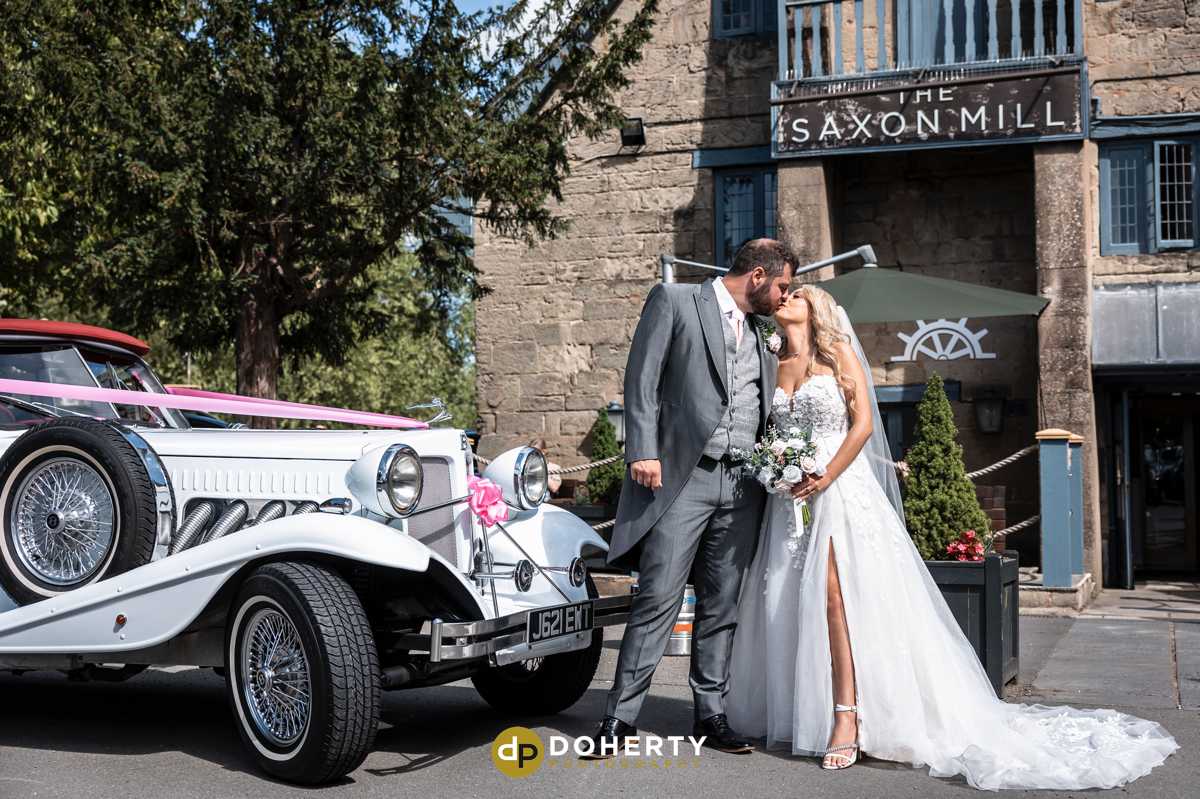 Saxon Mill Wedding Photography Warwick with bride and groom and car