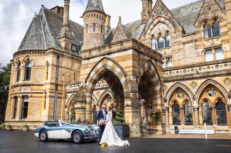 Wedding Photo of bride an dgroom with car outside Ettington Park Hotel
