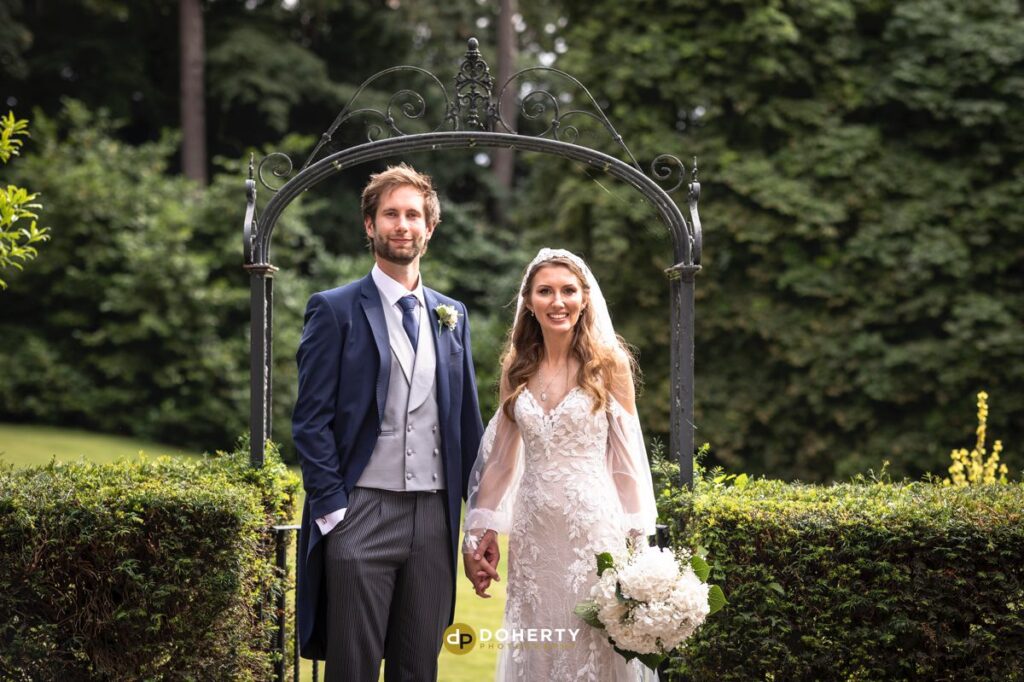 Brownsover Hall Wedding Photos with bride and groom in the gardens
