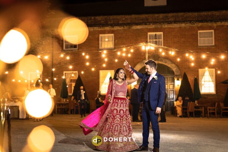 bride and groom dancing outside at Fawsley Hall wedding