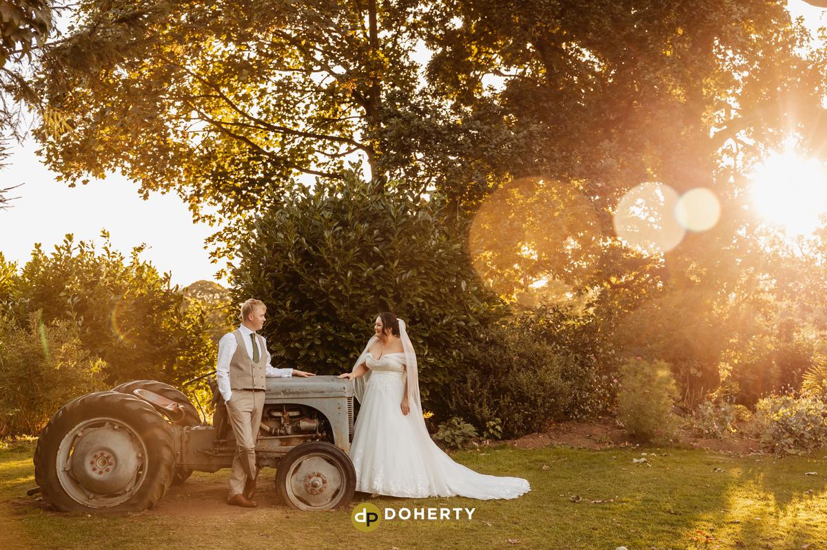 Bride and groom at sunset at Ashton Lodge Country House - Tractor